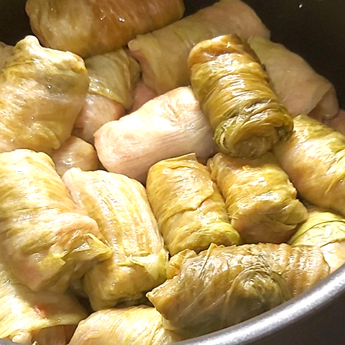 sarma rolls layered in a pot